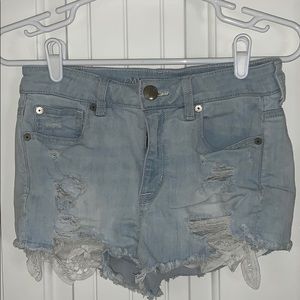light wash ripped denim shorts with lace pockets